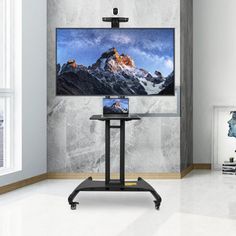 a flat screen tv sitting on top of a metal stand