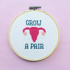 a cross stitch hoop with the words grow a pair on it