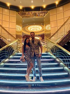 a man and woman are standing on the stairs