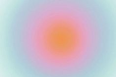 an orange and pink circle is shown in the middle of a blurry background with light blue