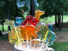 a cup filled with gummy bears sitting on top of a table