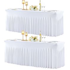 two tables covered in white tablecloths with candles and flowers