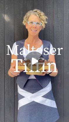 a woman holding a donut in front of a wooden wall with the words matress twin on it