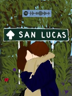 two people hugging under a street sign that says san lucas