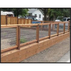 a wooden fence with wire around it