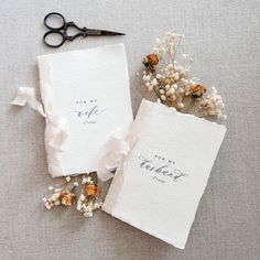 two wedding guest book with flowers and scissors