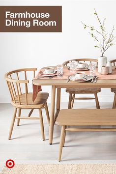 a dining room table with chairs and plates on it, next to a vase filled with flowers