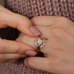 a woman's hands holding a diamond ring