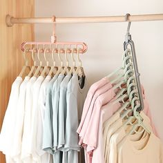 a rack with clothes hanging on it next to a wall