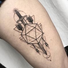 a black and white tattoo with an arrow on the thigh