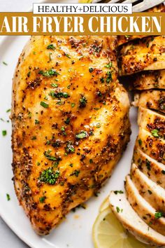 the best air fryer chicken recipe on a plate with sliced lemons and parsley