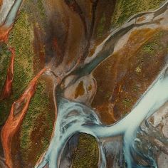 an aerial view of a river flowing between two mountains