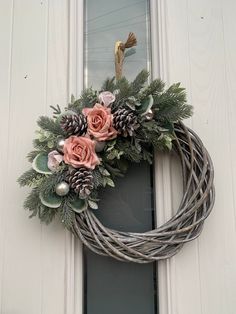 winter door wreath/ peach roses/ pine like foliage/ pine cones/ silver baubles/ tiny peachy pink roses/ on a 35 cm wicker wreath Winter Door Wreath, Wicker Wreath, Silver Baubles, Winter Door, Wreath Winter, Festive Wreath, Peach Roses, Winter Wreath, Peachy Pink