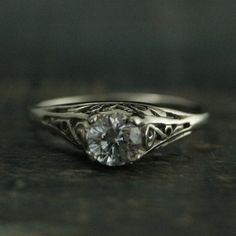 a white gold ring with a diamond in the center