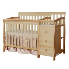 a wooden crib with two drawers next to it