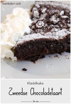 a close up of a piece of cake on a plate with whipped cream and chocolate