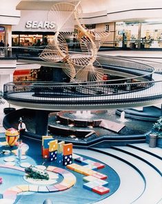 the inside of a shopping mall with lots of furniture and decorations on display in it