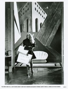 an old photo of a woman holding shopping bags