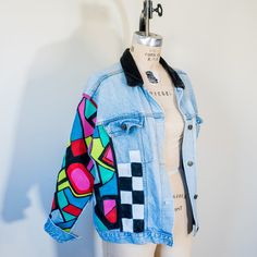 This vintage denim jacket has 80s energy through and through. Featuring a black velvet collar and hand-painted geometric designs up the front and down the right arm, sis looks good with anything. "Scattered" is an upcycled flea-market gem; it's one of a kind, pre-broken-in, AND planet-friendly. All this so you can steal the show AND feel extra extra good about your purchase. Product Details: Upcycled denim jacket Silver snap closures Side pockets Faux breast pockets Classic side pockets Black ve 80s Denim Jacket, 80s Jacket