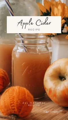 an apple cider recipe in a jar with apples and oranges next to it