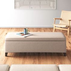 a living room with a couch, chair and coffee table on it's wooden floor