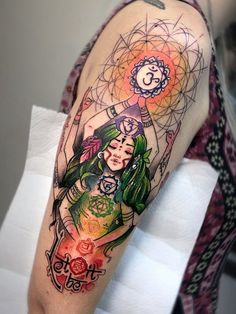 a woman's arm with an artistic tattoo design on the upper half of her arm