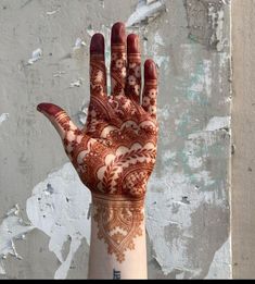 a woman's hand with henna on it