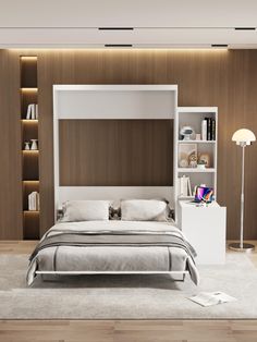 a bedroom with a bed, bookcases and shelves in the wall behind it