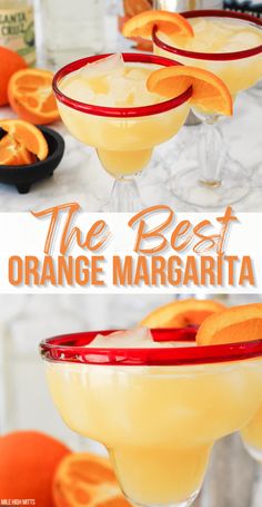 two glasses filled with orange margaritas sitting on top of a table next to an orange slice