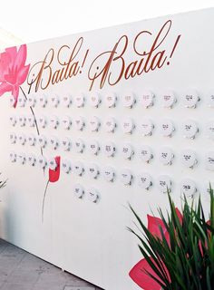 a large white wall with flowers on it and the words batta e batta