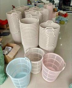 several white and pink baskets sitting on the floor