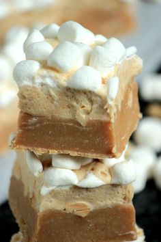 three pieces of dessert with marshmallows stacked on top of eachother