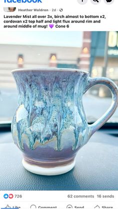 a coffee cup sitting on top of a car dashboard