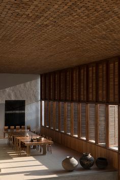 an empty room with several vases on the floor