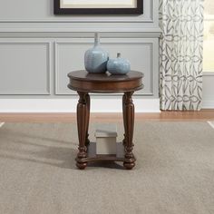 a table with two vases on top of it in front of a painting and window