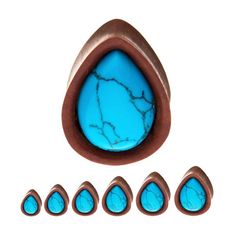 six turquoise stone cabochons with copper tips and an oval shaped blue cabochon