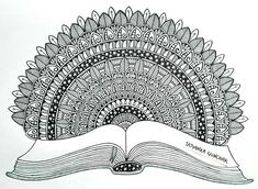 an open book with intricate designs on it