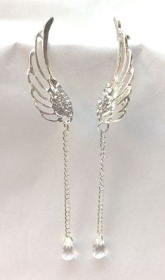 "Elegant, Beautiful Earrings, Dangle Style. All Occasion Piece, Very Exquisite Long Dangle Angel Wings Design with Rhinestone Accents and Chain. Ear cuff at top to hold them in place. Silver Tone. Approx. Size 4\" long" Gold Angel Wing Earrings, Angel Wing Accessories, Angel Wing Jewelry, Angelic Jewelry, Angelic Accessories, Angel Wedding, Angel Accessories, Wings Jewelry, Wedding Angels