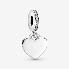 Your jewelry can now be as unique and special as you are with this Engravable Heart Tag Dangle Charm in sterling silver. This heart-shaped tag features an engravable front and back, where you can get the names of your friends, family and loves inscribed. A line of clear cubic zirconia accentuates the top and provides a touch of eye-catching sparkle. It’s easy to create your own unique style with a piece that is easy to personalize – the only limit is your imagination. Charms Pandora, Bracelet Pandora, Heart Tag, Custom Pendants, Bracelet Cuir, Charms And Charm Bracelets, Engraved Necklace, Bracelet Argent, Engraved Items