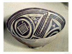 a black and white bowl sitting on top of a table