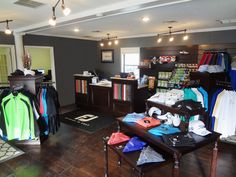 the inside of a clothing store with clothes on display