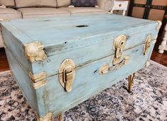 an old trunk sitting on top of a rug