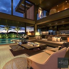 a living room filled with furniture next to a swimming pool