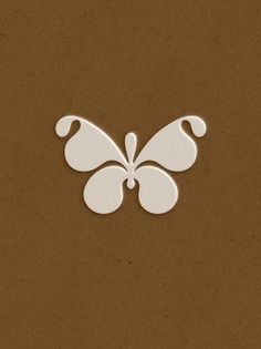 a white butterfly on a brown background