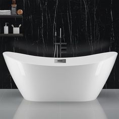 a white bath tub sitting on top of a bathroom floor next to a black wall