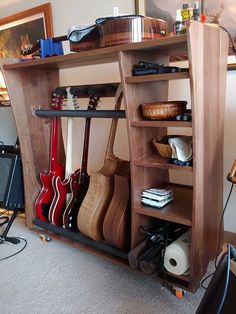 a shelf with guitars and other musical instruments on it's sides in a living room