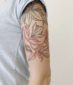 a person with a flower tattoo on their arm and shoulder is looking at the camera