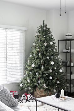 a living room with a christmas tree in the corner