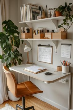 a desk with a chair, bookshelf and plants on it in the corner