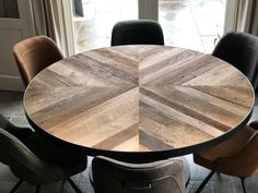 a round wooden table with four chairs around it